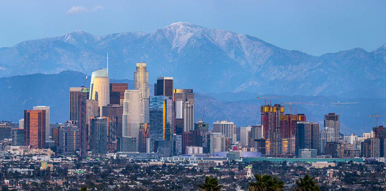 skyline of city with mountains in the background