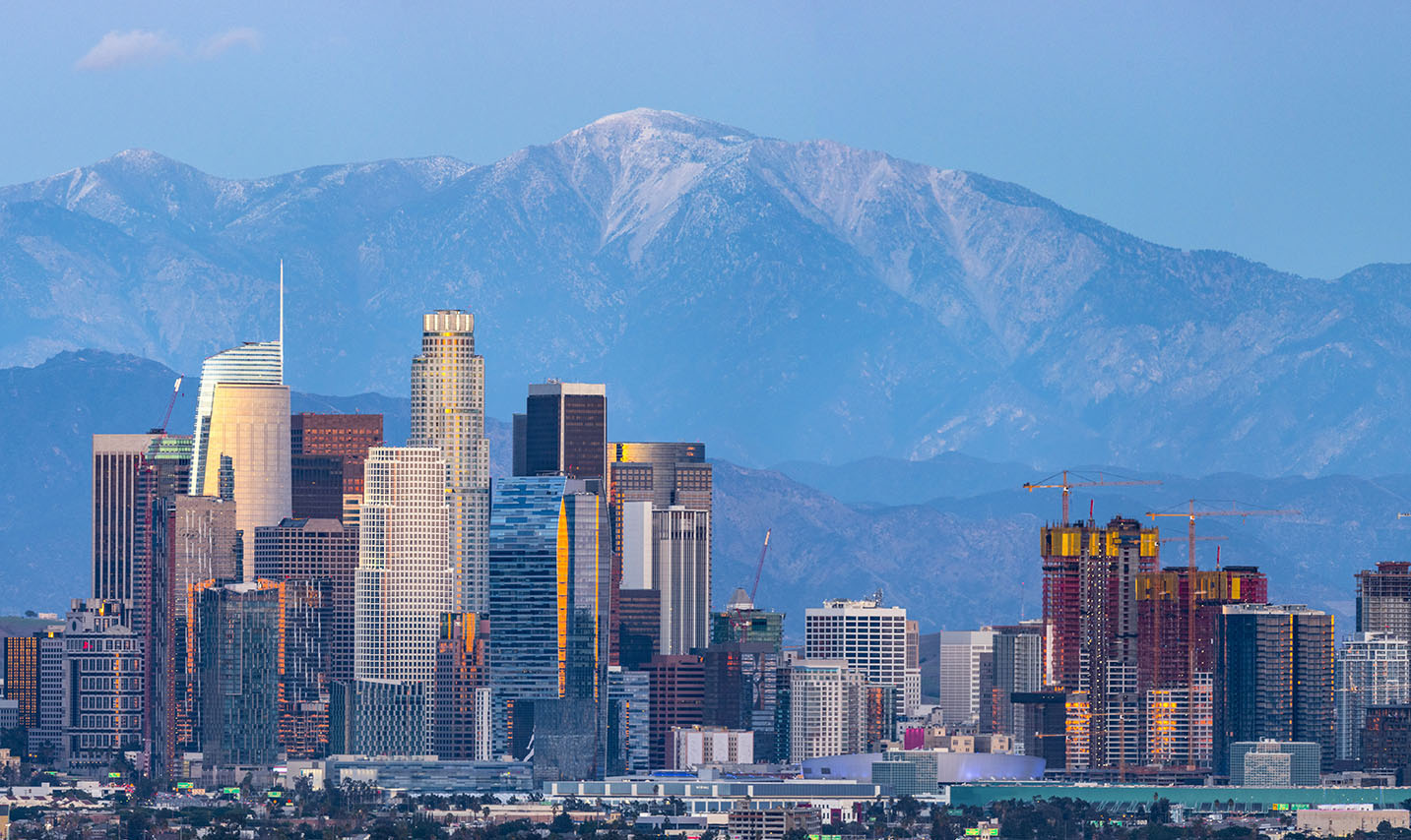 skyline of city with mountains in the background